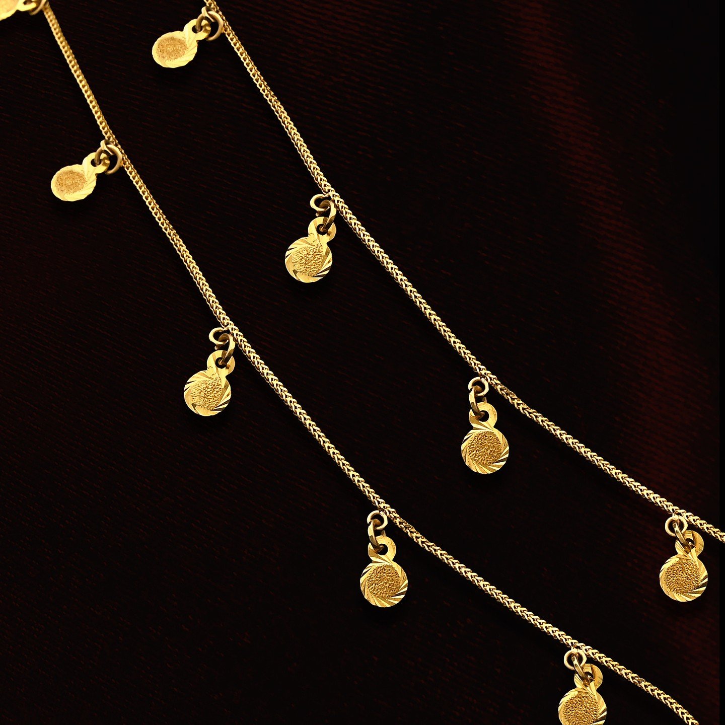 _kundan_jeweller_1661512658_2913301794348695893_54386949274 Delicate Gold Chain with Textured Dangling Charms - Image 1